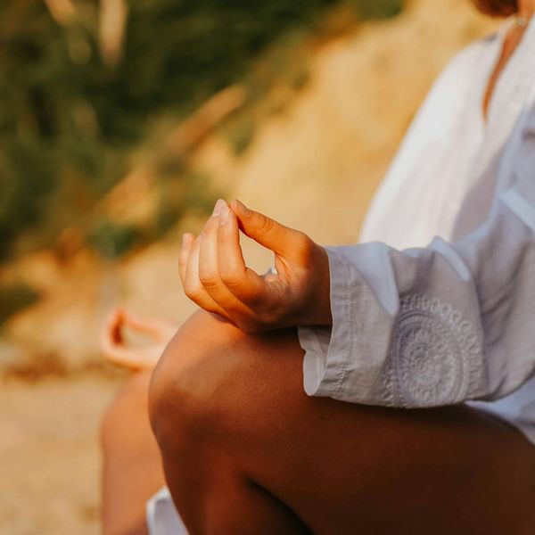 Close-up of hands in mudra symbolizing focus and inner energy flow